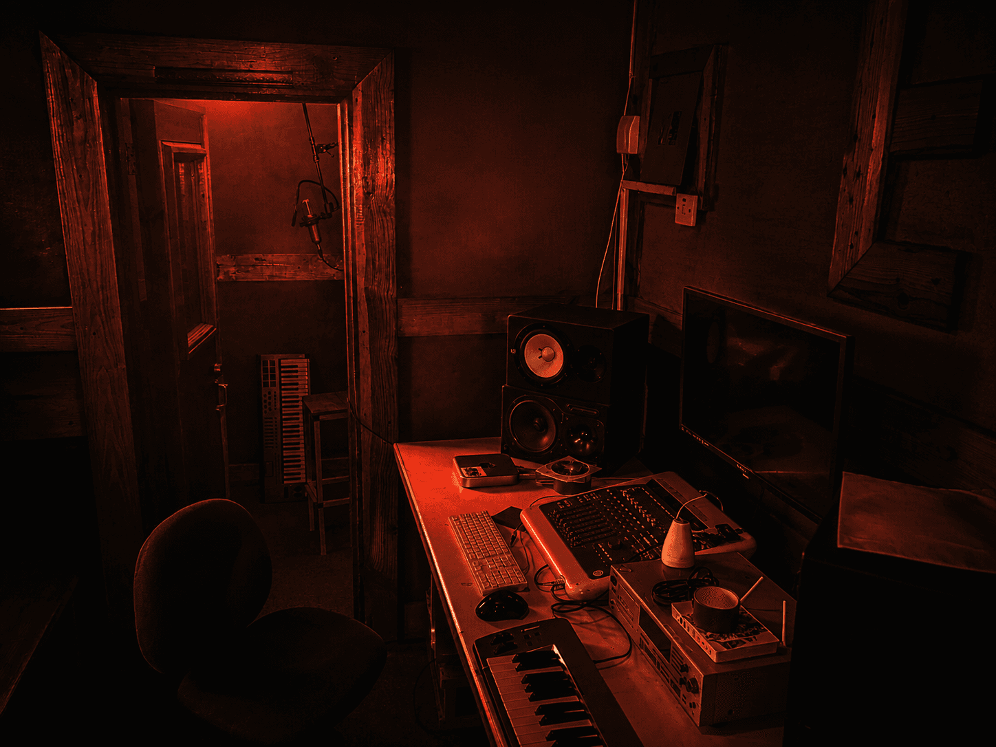 Exodus Nuclear recording studio control room in cinematic red light